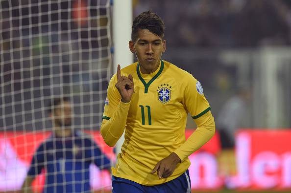 Brazil's forward Roberto Firmino celebrates after scoring the team's second goal against Venezuela during their 2015 Copa America football championship match, at the Estadio Monumental David Arellano in Santiago, on June 21, 2015.    AFP PHOTO / PABLO PORCIUNCULA        (Photo credit should read PABLO PORCIUNCULA/AFP/Getty Images)