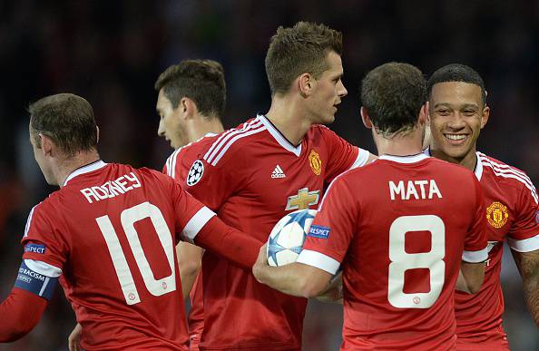 Manchester United's Dutch midfielder Memphis Depay (R) is congratulated after scoring his team's second goal during the UEFA Champions League play off football match between Manchester United and Club Brugge at Old Trafford in Manchester, north west England, on August 18, 2015. AFP PHOTO / OLI SCARFF (Photo credit should read OLI SCARFF/AFP/Getty Images)