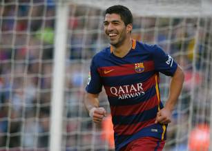 Barcelona's Uruguayan forward Luis Suarez celebrates after scoring his team's second goal during the Spanish league football match FC Barcelona vs Real Sociedad de Futbol at the Camp Nou stadium in Barcelona on November 28, 2015.   AFP PHOTO/ LLUIS GENE / AFP / LLUIS GENE        (Photo credit should read LLUIS GENE/AFP/Getty Images)