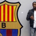 Barcelona's new soccer player Seydou Keita of Mali gestures in front of the Barcelona office after signing a contract at the Nou Camp stadium in Barcelona